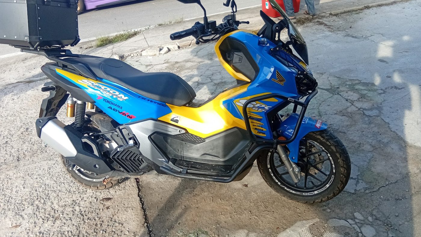 Blue and yellow Honda ADV-style scooter