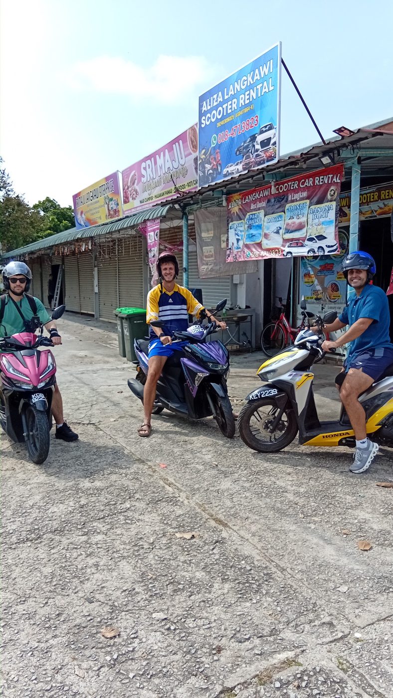 Riders on rental scooters in front of the shop