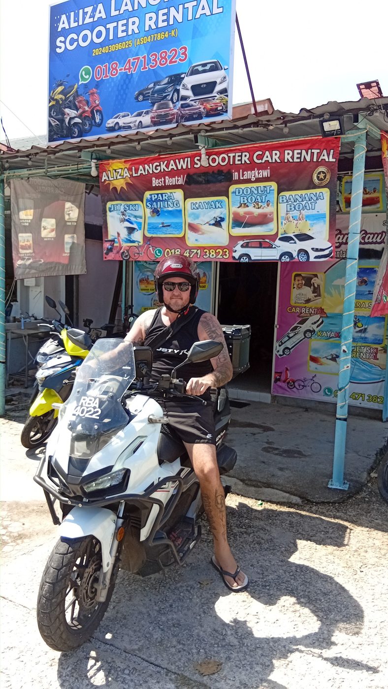 Rider on a Honda ADV in front of the shop